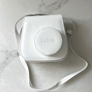 Used a handful of times Instax camera case in bright white. Excellent condition.